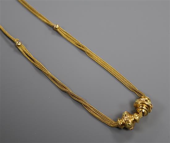 A late 19th/early 20th French 18ct two colour yellow metal double and triple chain necklace with sliding turned batons, 46cm.